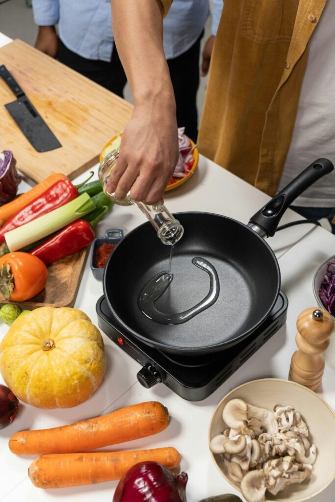 A person cooking vegetables in a pan during a Creative Expression activity